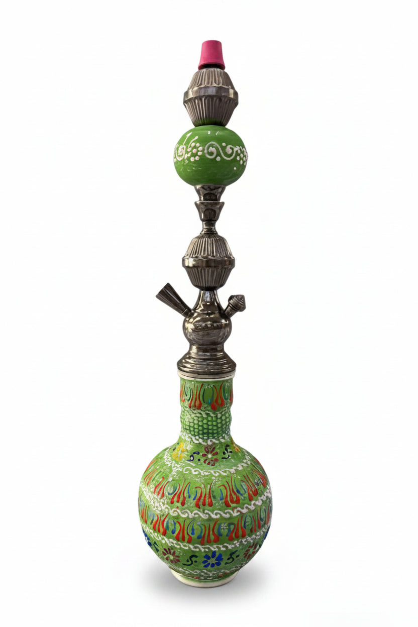 Decorative hookah with intricate designs on a white background