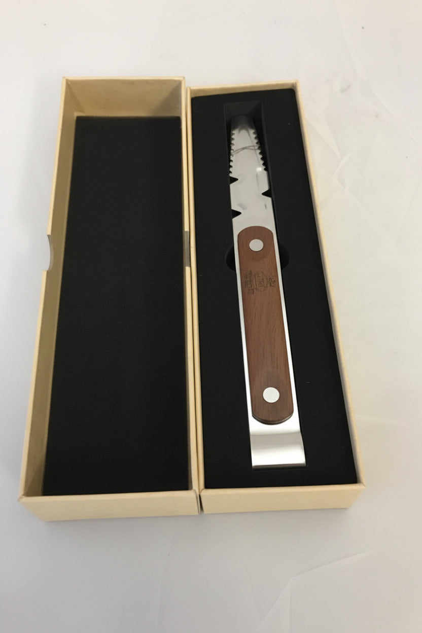 A multi-tool with a silver metal body and a brown wooden handle, presented inside its open beige gift box with black foam insert.
