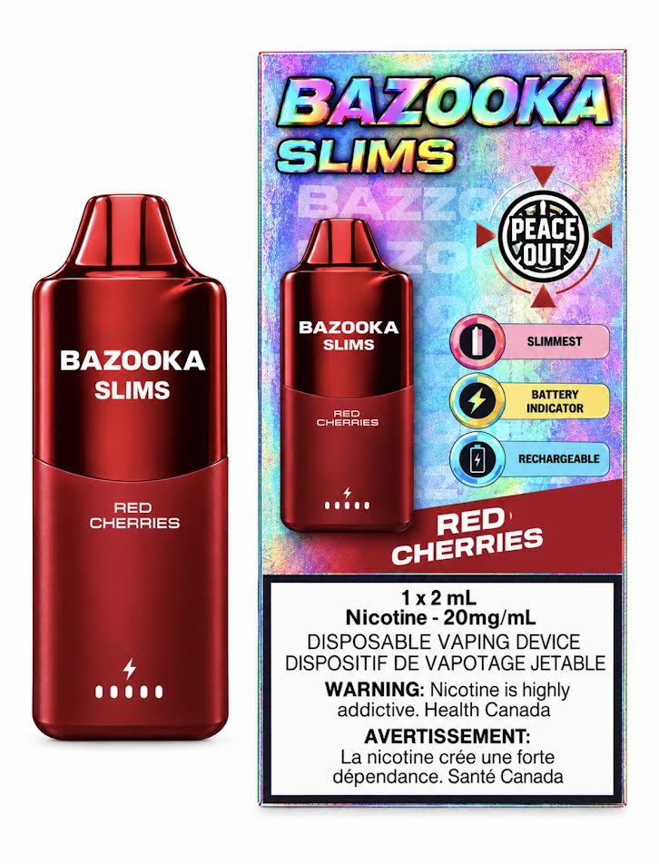 A blue Bazooka Slims disposable vaping device stands next to its retail box on a clean white background. The packaging is blue and white with 'BAZOOKA SLIMS' and 'RED CHERRIES' printed on it, plus a Peace Out badge and a nicotine warning label.
