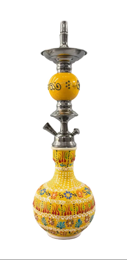 Decorative yellow hookah with floral patterns on a white background